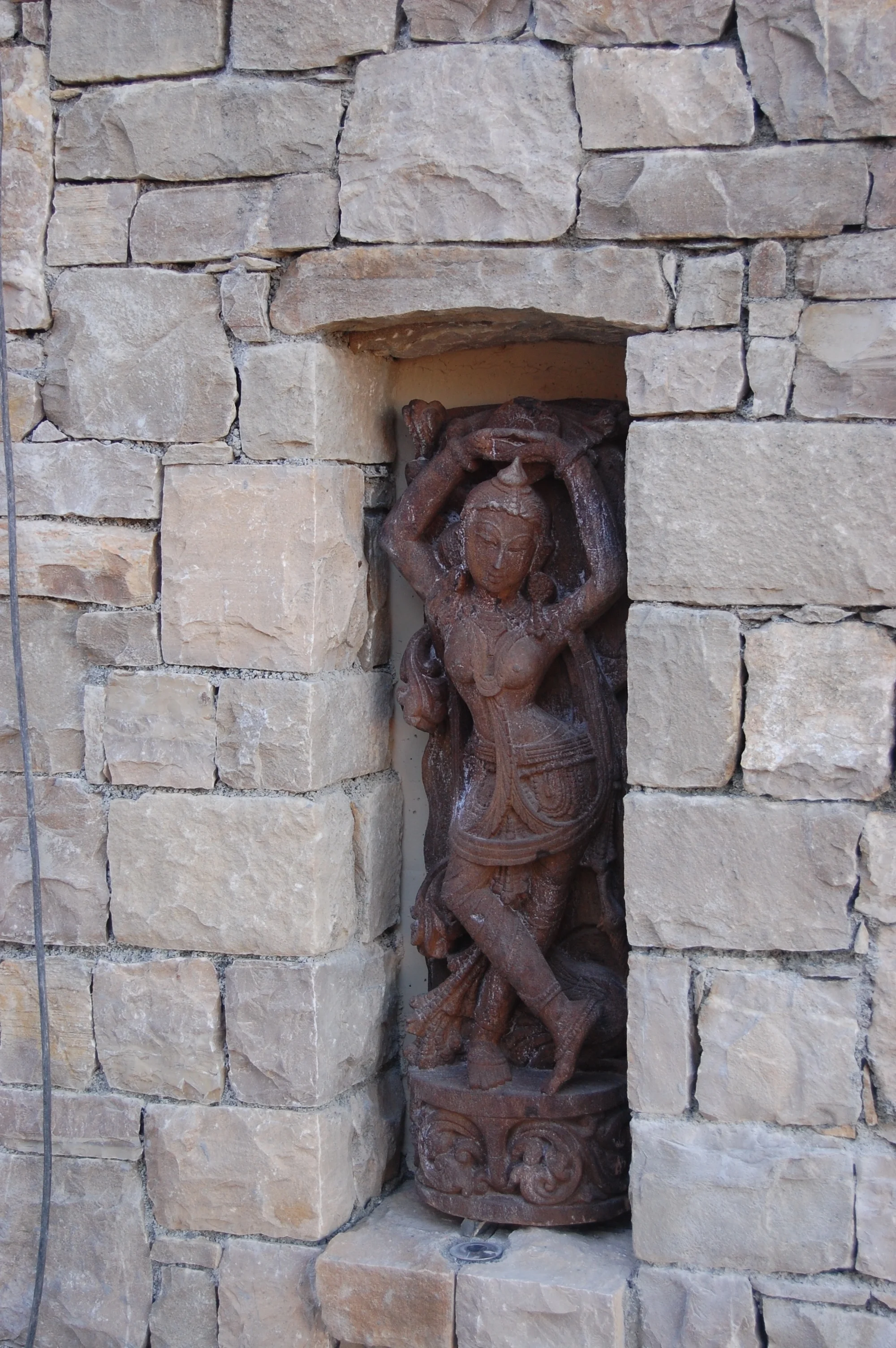 One of three sculptures artfully displayed and lit at night.