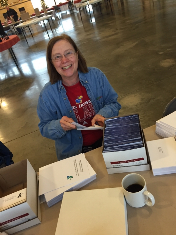 Margie Dyck, current Camp Wood YMCA board member and descendant of Stephen and Caroline Wood, helps with a Christmas card mailing earlier this December.