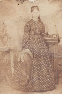 Young Caroline (Breese) Wood stands for a photograph.