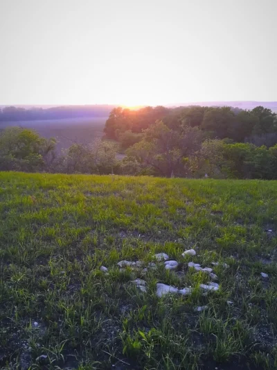 An old fire ring set along the bluff was exposed by spring burns. The current Coyote Triangle fire ring is set nearer to some trees along the hillside's northern point.