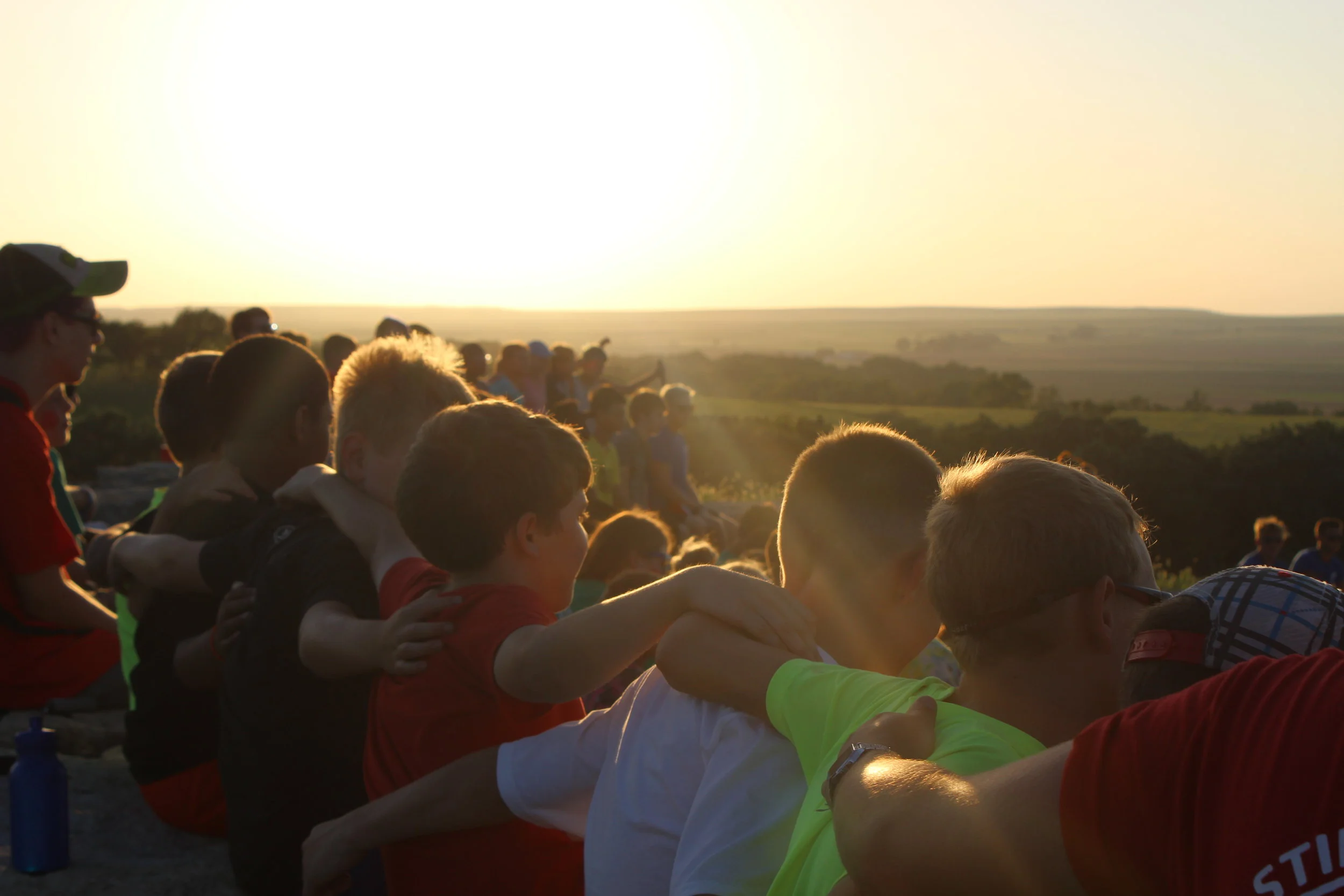 Campers enjoying their last evening together at closing campfire. It's still just as hard to say goodbye to camp friends at the end of a week.