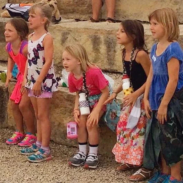 Lizzie, second from right, getting into the songs at opening campfire during Mini-Camp in 2016.