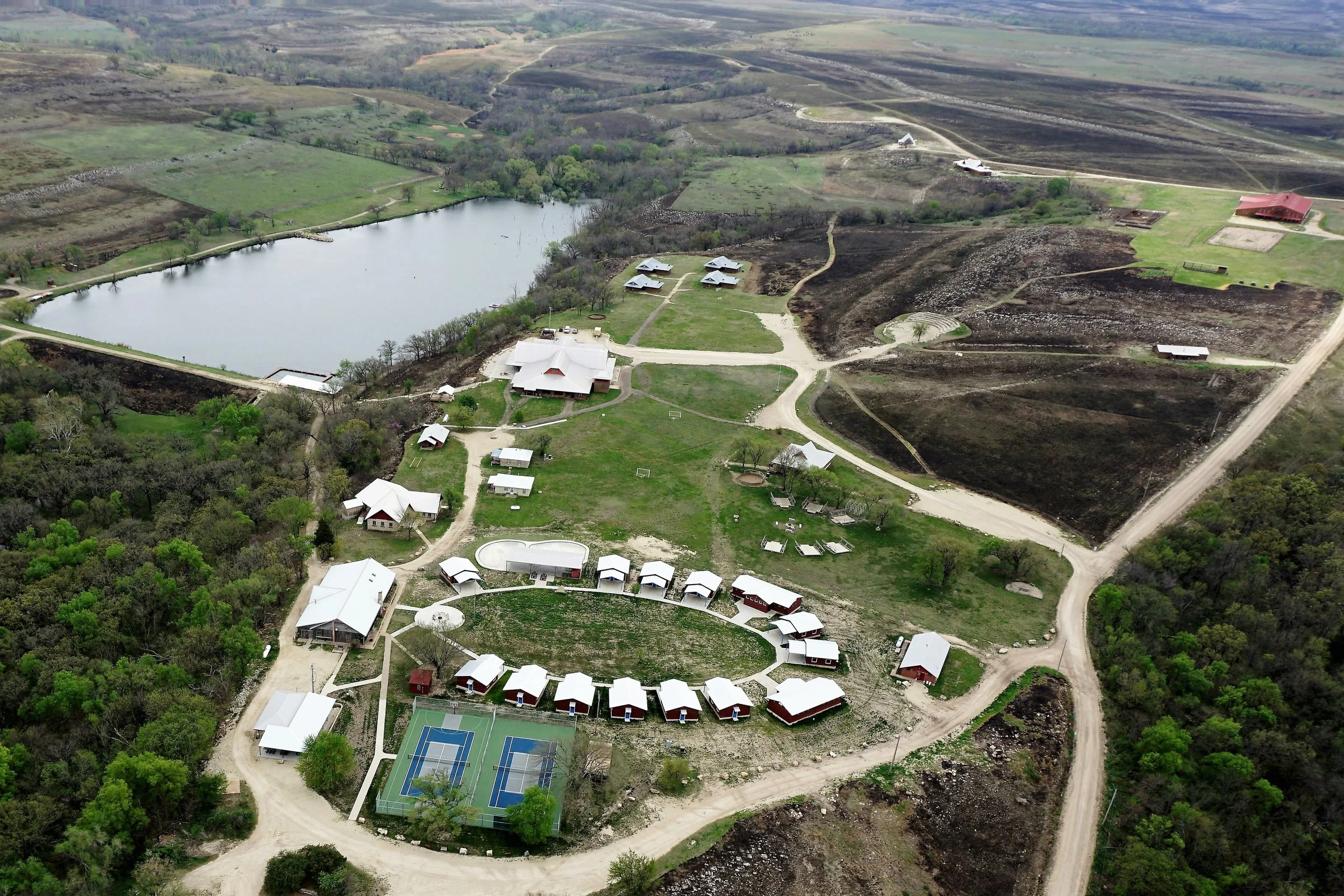 From the hill to your left as you drive into camp, to the land beyond the horse barn and surrounding the new Preston Outdoor Education Station, to the hill across the lake where you can still see the names of campers' towns put there in stone early in camp's history--we burn a lot of camp's property. The areas closest to most of our buildings are not burned (for obvious reasons) but we do mow those areas.