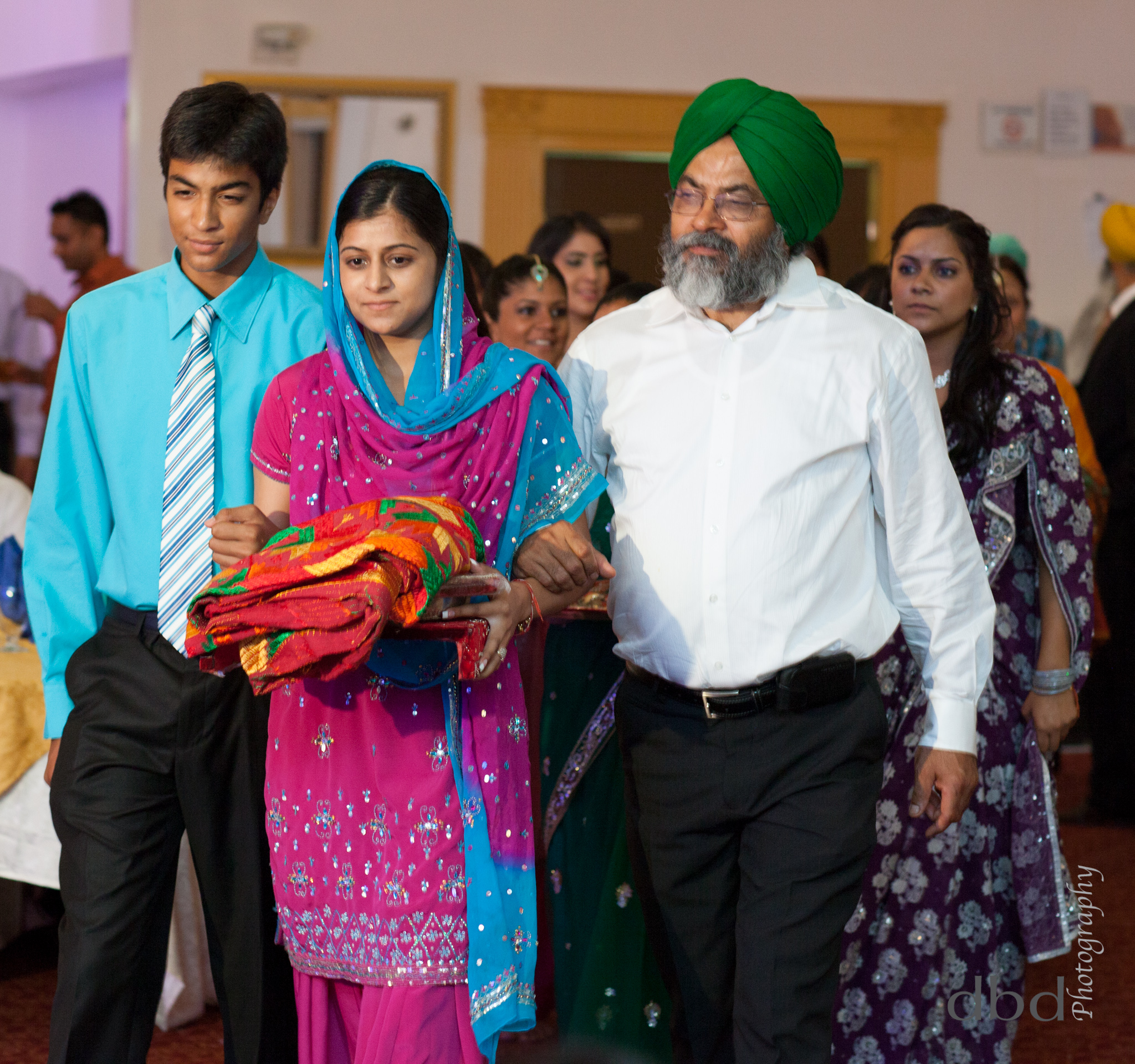  Preet is ushered in to the ceremony by her father and brother, carrying the items she will need on the&nbsp; thaal  (tray) 