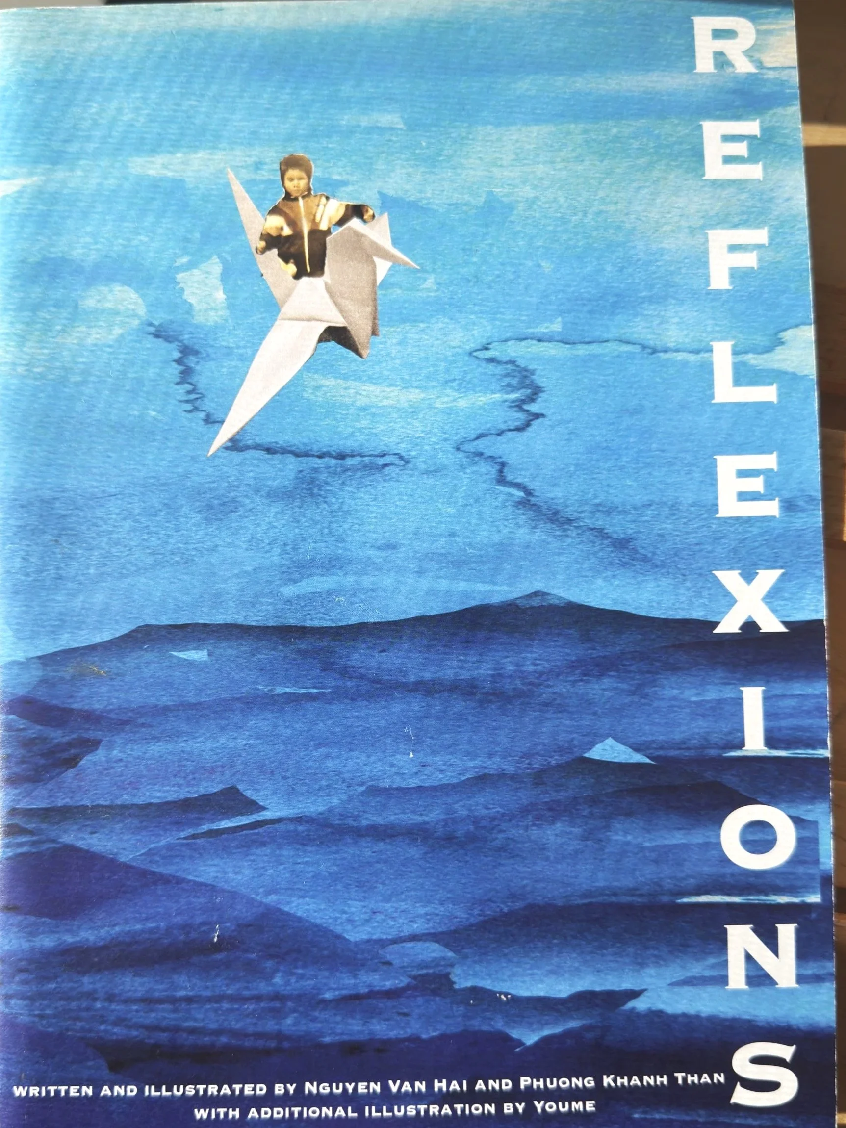 cover of comic book titled reflexions,a small child rides a paper crane through a blue watercolor sky, written and illustrated by Nguyen Van Hai and Phuong Khanh Than with additional illustration by Youme