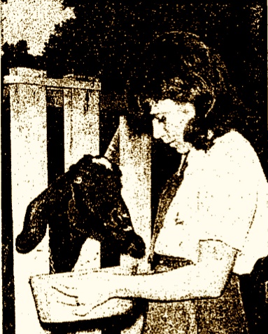 Campfire Girl Charlene Spratt feeds a goat during camp at Camp Chiquita, 1969. Los Angeles Times.