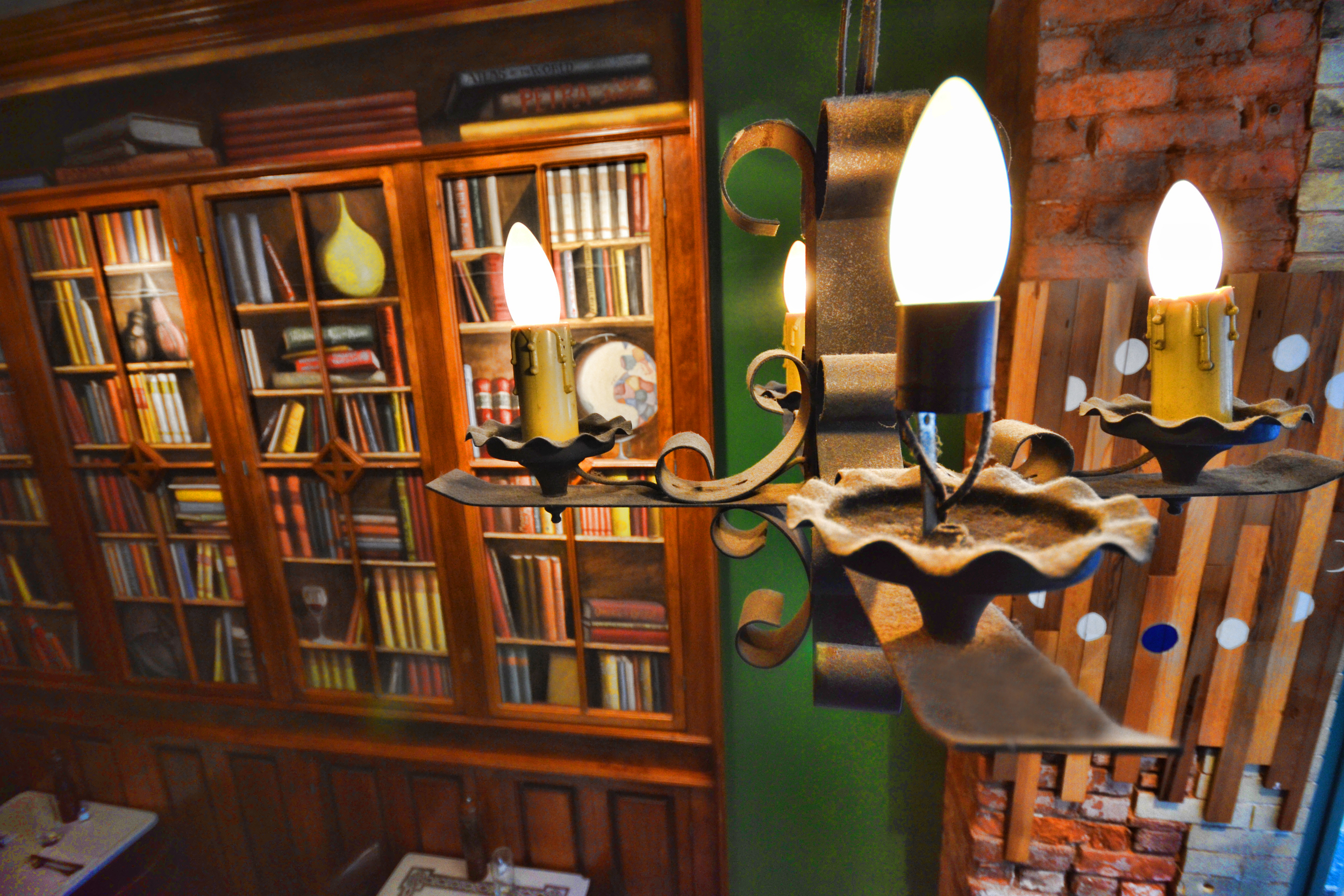 the chandelier and bookcases in the den