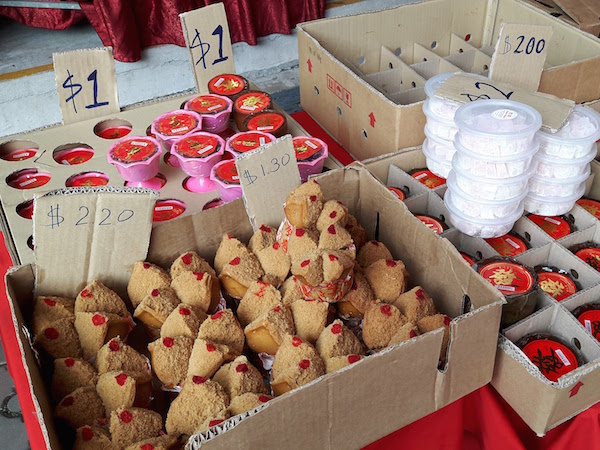 Brown cupcakes 'huat kuey' in Hokkien are offered to the deceased. 'Niangao' round cakes with red labels on them. 