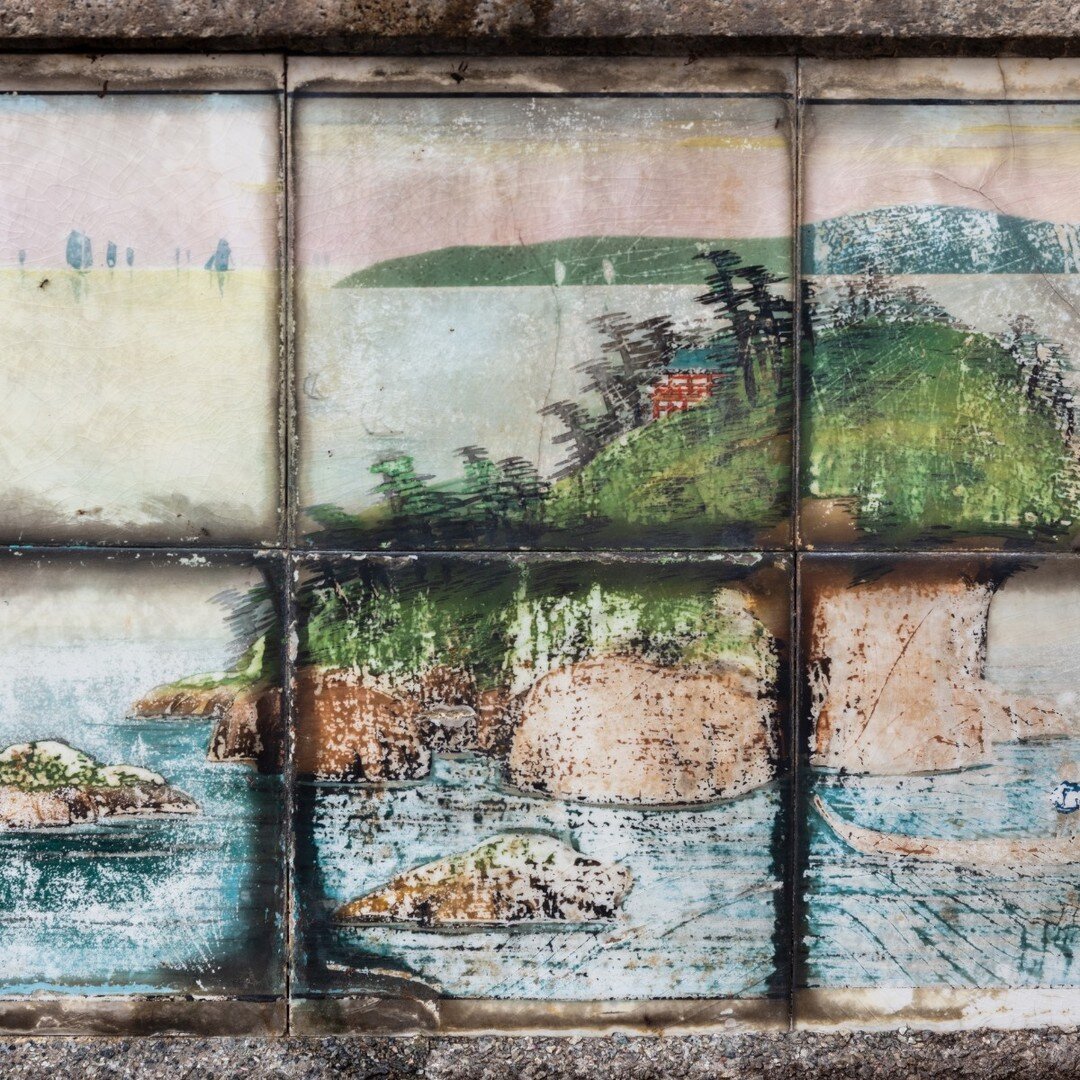This handpainted landscape tile panel decorates the tomb of my great-grandparents. Dating back to at least 1936, this rare panel shows an idyllic scene of an island, possibly with a shrine at the top. I can also see boats in the distance. Could this 