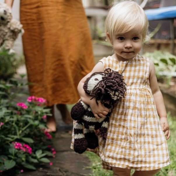 A girl and her zebra. Beautiful shot by @debibrettphotography. These cooler months are seeing a big increase in demand for the homespun wool critters, our safari zebras pictured here are currently available in Medium only x 
#choosewool
#changinglive