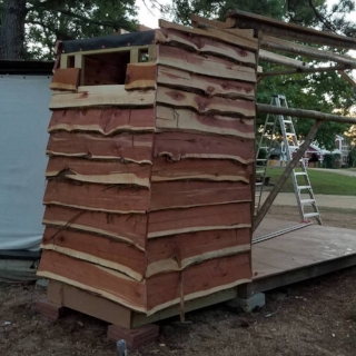 The siding going up... not easy to do with boards that are not straight/square.