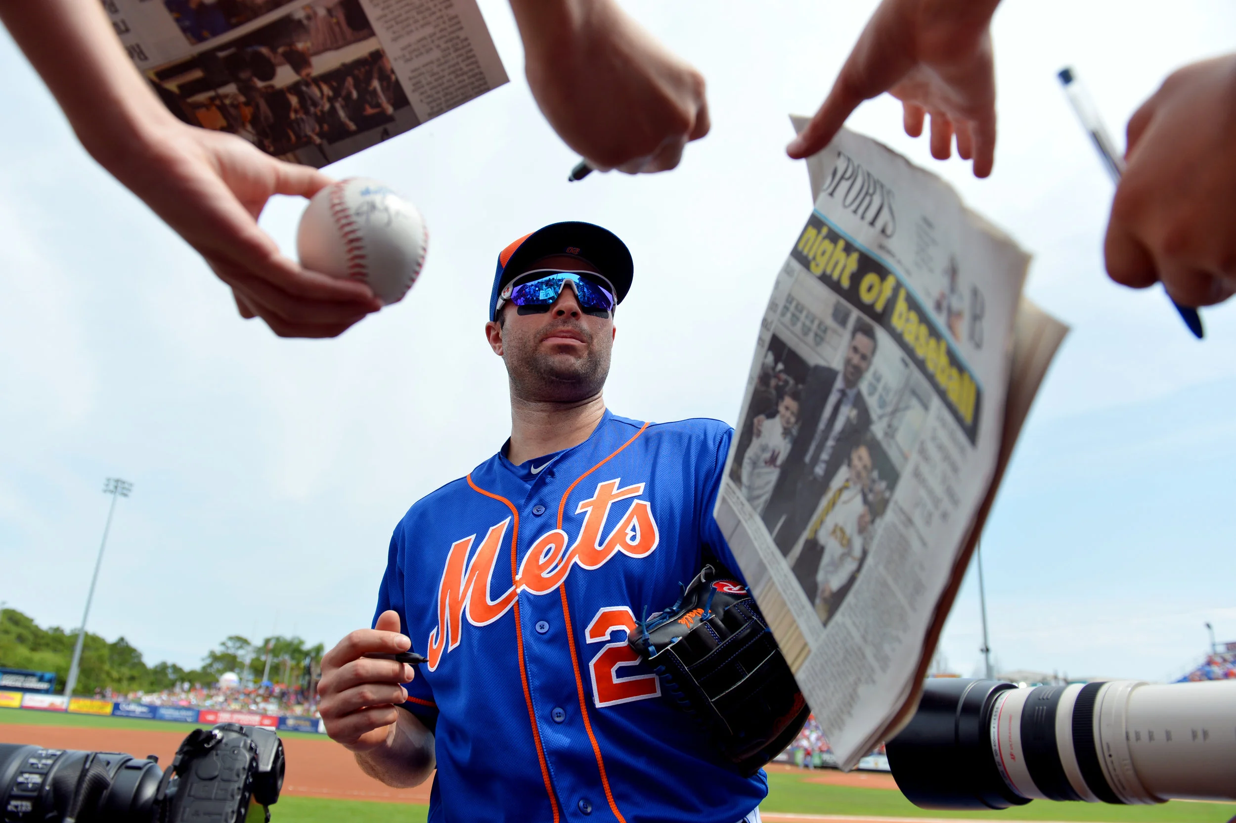  New York Mets infielder Neil Walker signs autographs for fans Friday prior to a spring training game against the St. Louis Cardinals at Tradition Field in Port St. Lucie.&nbsp; 
