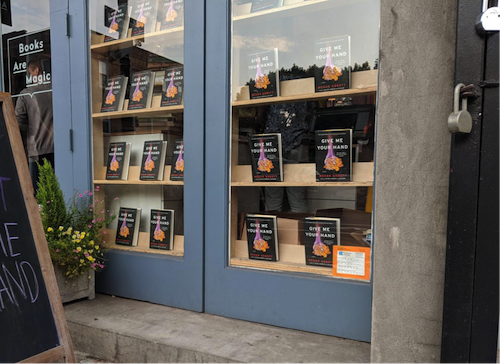 The window fronts at Books Are Magic decorated with Megan Abbott’s new novel, Give Me Your Hand.