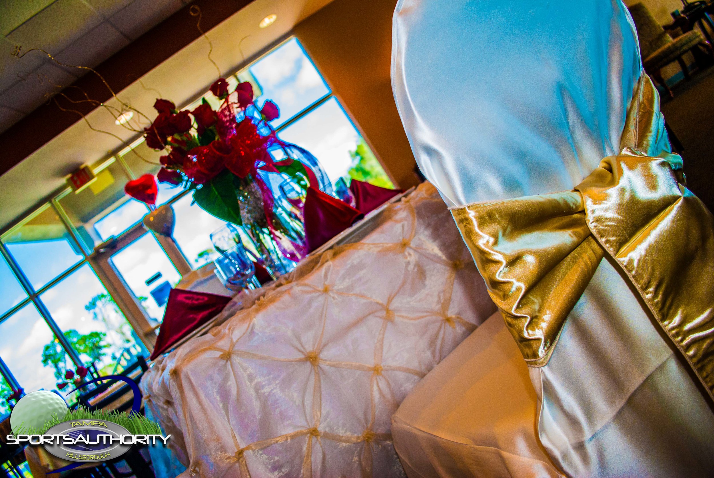 Flowers and decorations adorn a table set for an event meal.