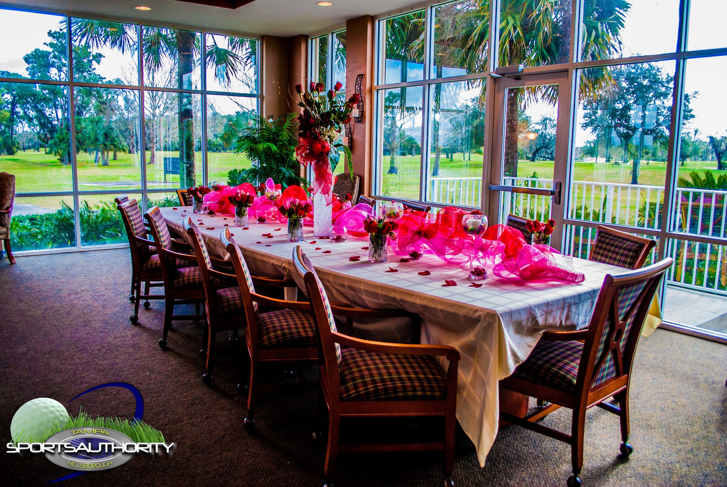 Flowers and decorations adorn a table set for an event meal.