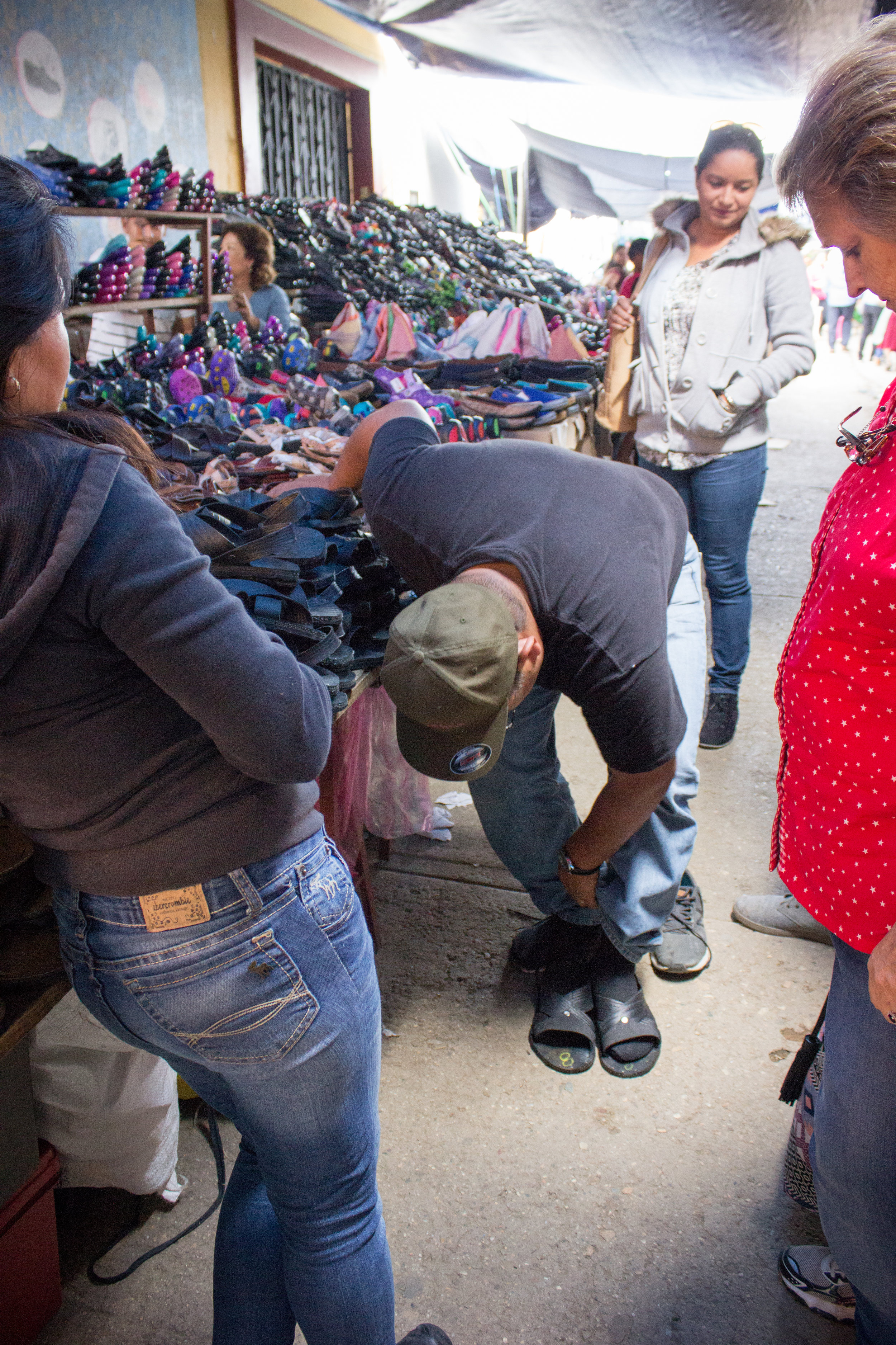  On June 27, Ilene, Junior, Maria, Manuel and I traveled to another part of Oaxaca. Here, Junior tries shoes on in a market where we stopped along the way. 