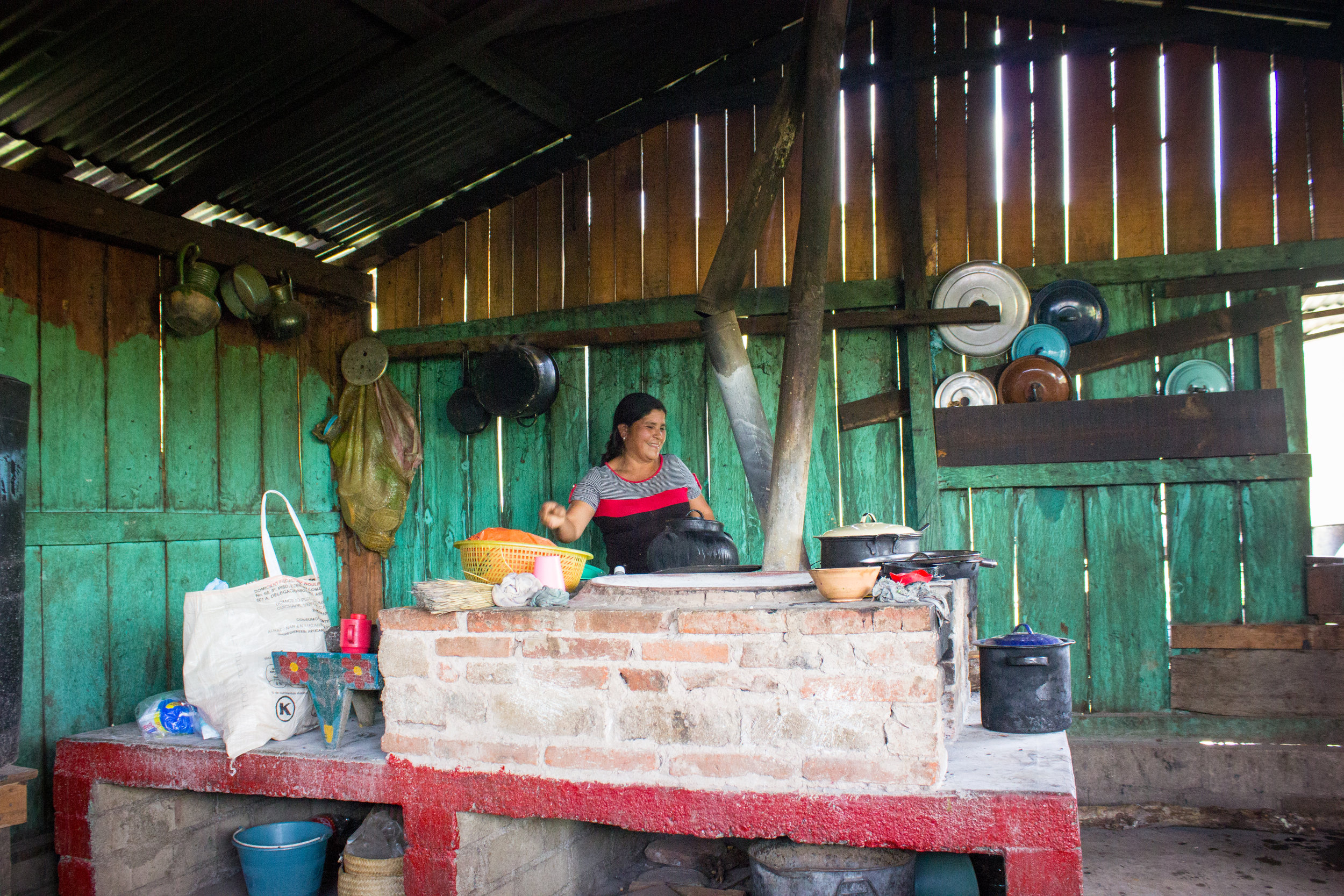  A neighbor in her kitchen, making a luncheon for all of us. In the villages, women cook over open fires in rooms separate from the homes. 