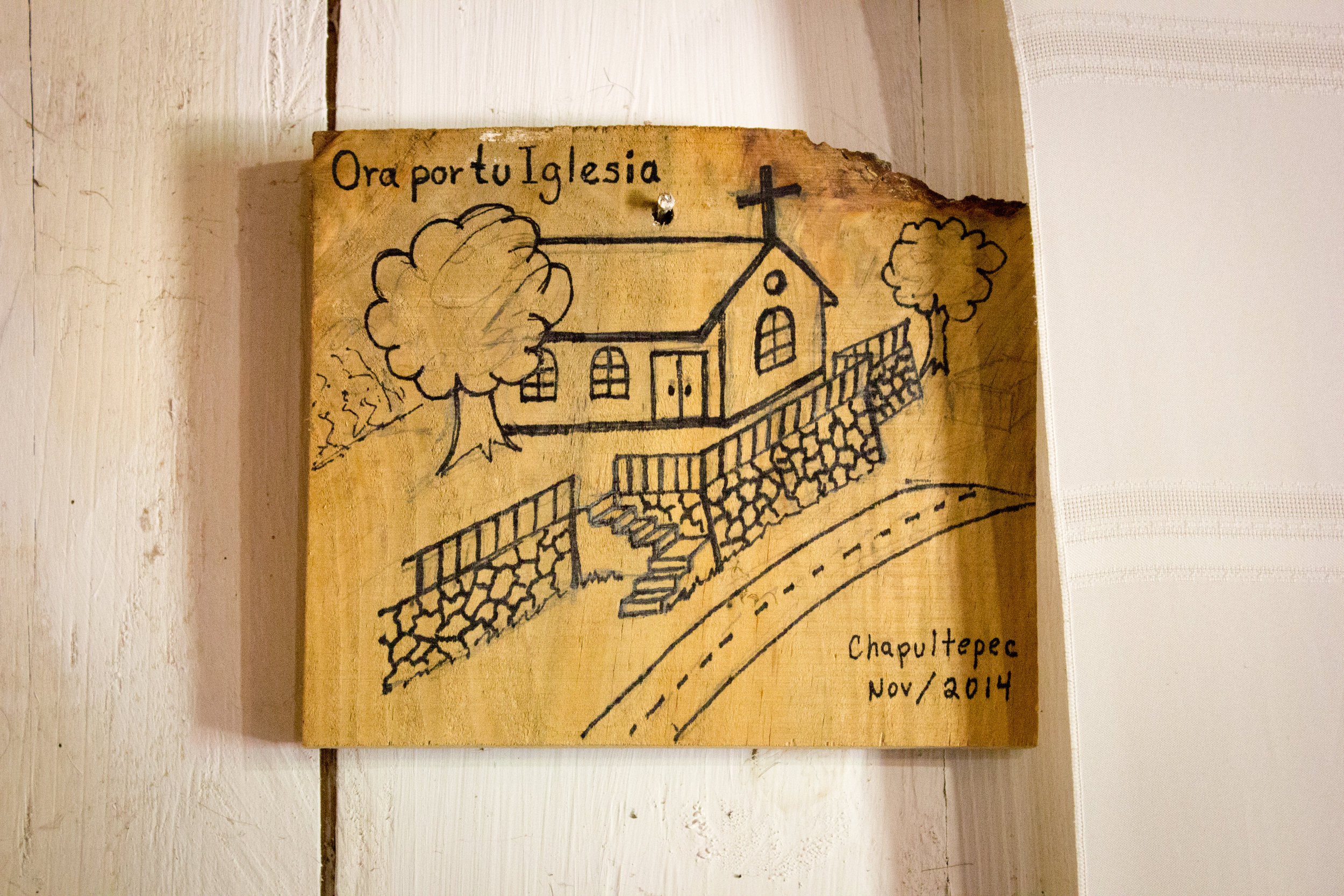  On the wall is a drawing that represents their dream of building a new church. 