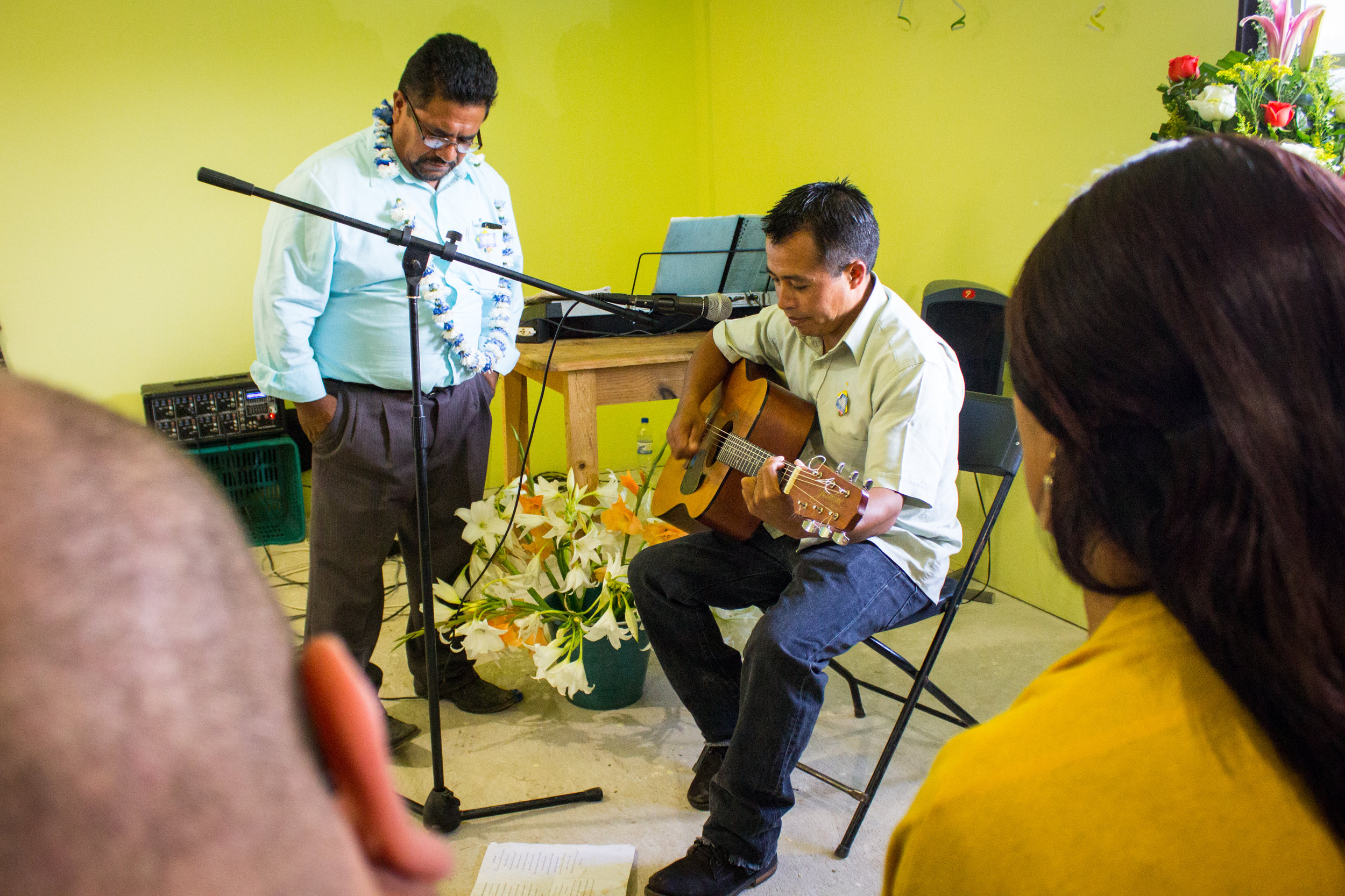  Senen and a church member sing at the end of the service. 