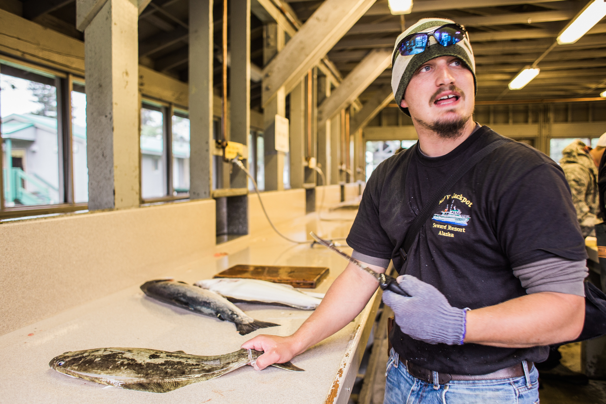 Here, Benjamin is filleting his customer's fish at the Seward Military Resort. 