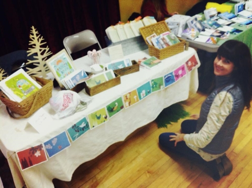 Here's a pic of me setting up. I had fun figuring out how to make a nice display of my products.