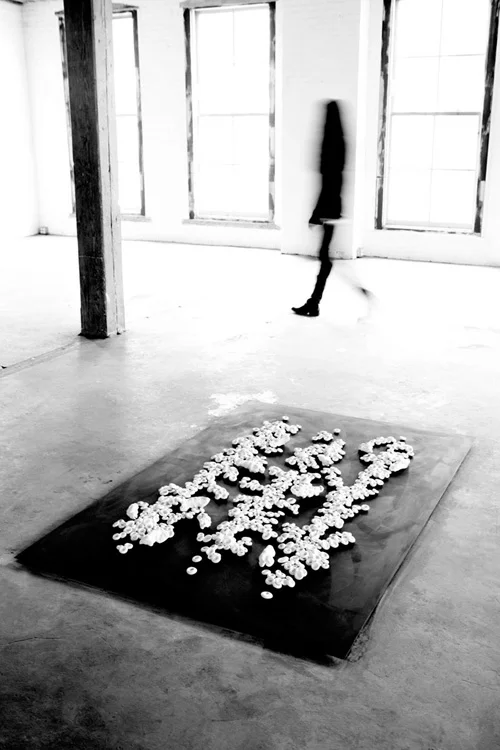 OFRENDA. 2013. Unfired porcelain clay, steel plate. 72 x 48 in. View of the exhibition WorkSpace. Invisible Dog Art Center Gallery. Brooklyn, New York. March 9, 2013