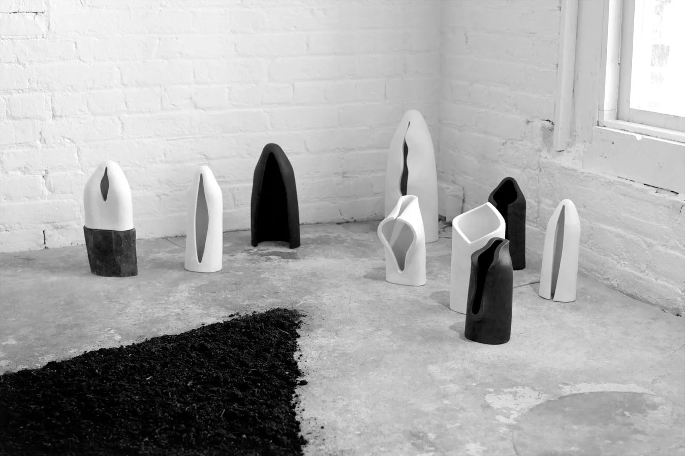 ICONOLOGY . 2012. Handbuilt porcelain, wood, gesso, acrylic paint, soil, a sacred book. Dimensions variable. View of WorkSpace Group Exhibition. Invisible Dog Art Center Gallery. Brooklyn, New York. March 10, 2012