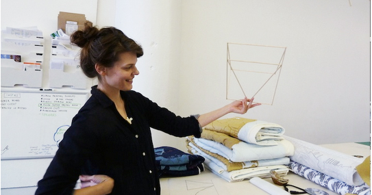 Emily Fischer holding a kite in progress.