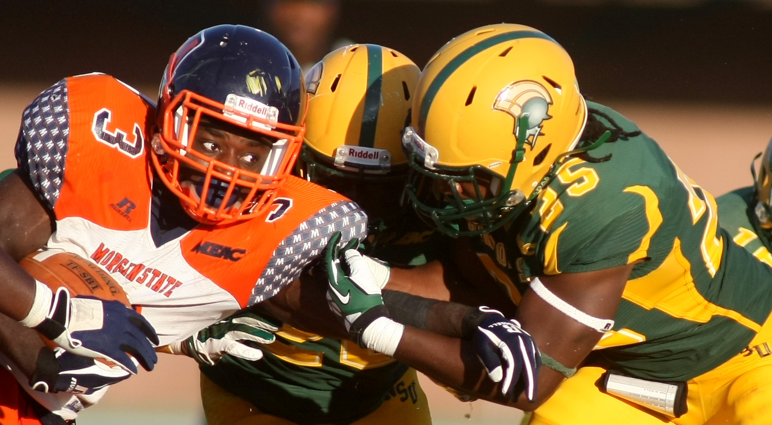 Norfolk State's Keenan Lambert, right, and Brandon Walker wrap up Morgan State's Herb Walker, Jr for a loss of yardage during NSU's 15-14 win, Saturday, Sept. 27, 2014 at Dick Price Stadium in Norfolk. (Jason Hirschfeld | For The Virginian-Pilot)