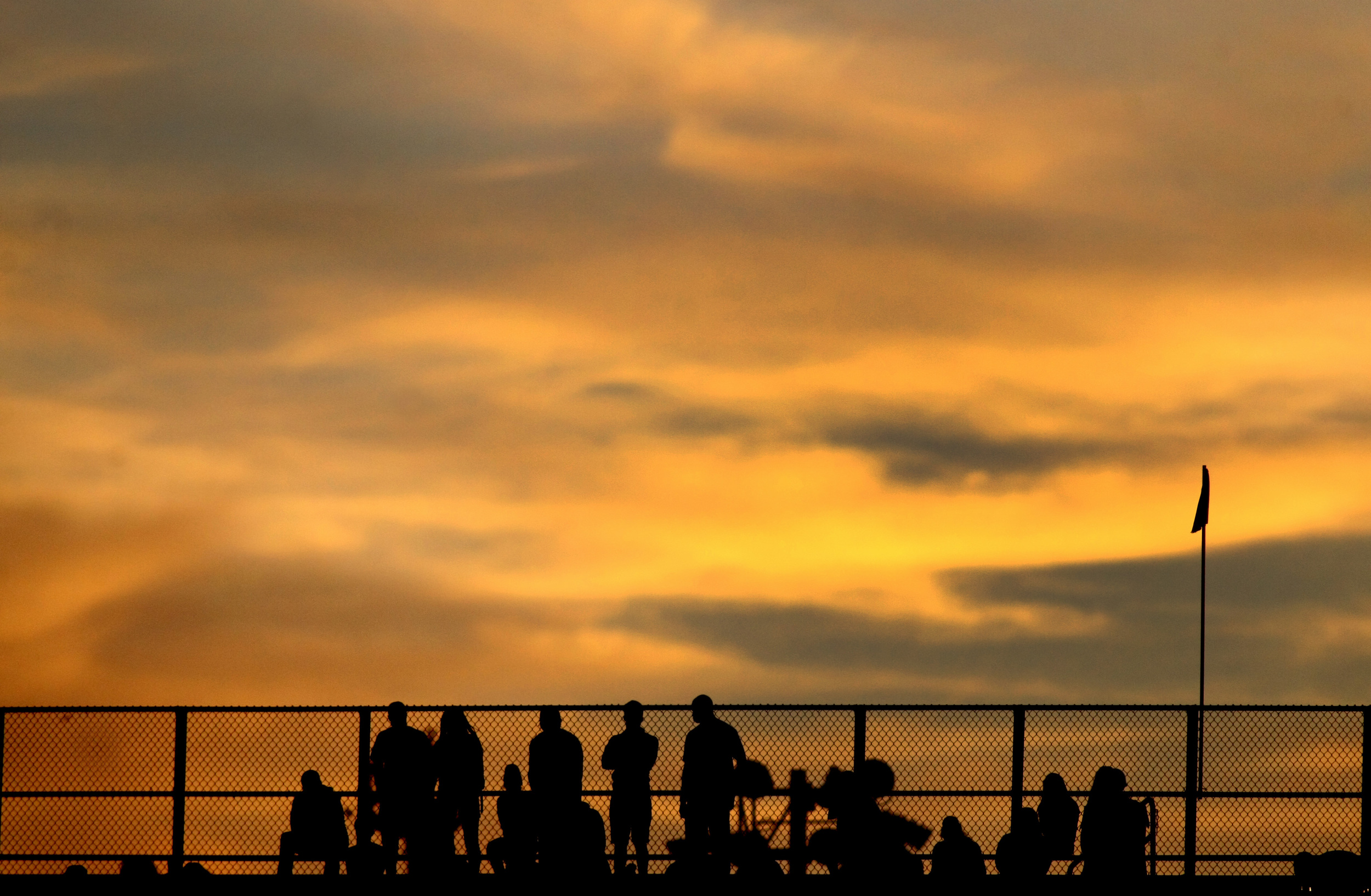 Fans watch the Norfolk State football game as the sun sets behind them during NSU's 15-14 win, Saturday, Sept. 27, 2014 at Dick Price Stadium in Norfolk. (Jason Hirschfeld | For The Virginian-Pilot)