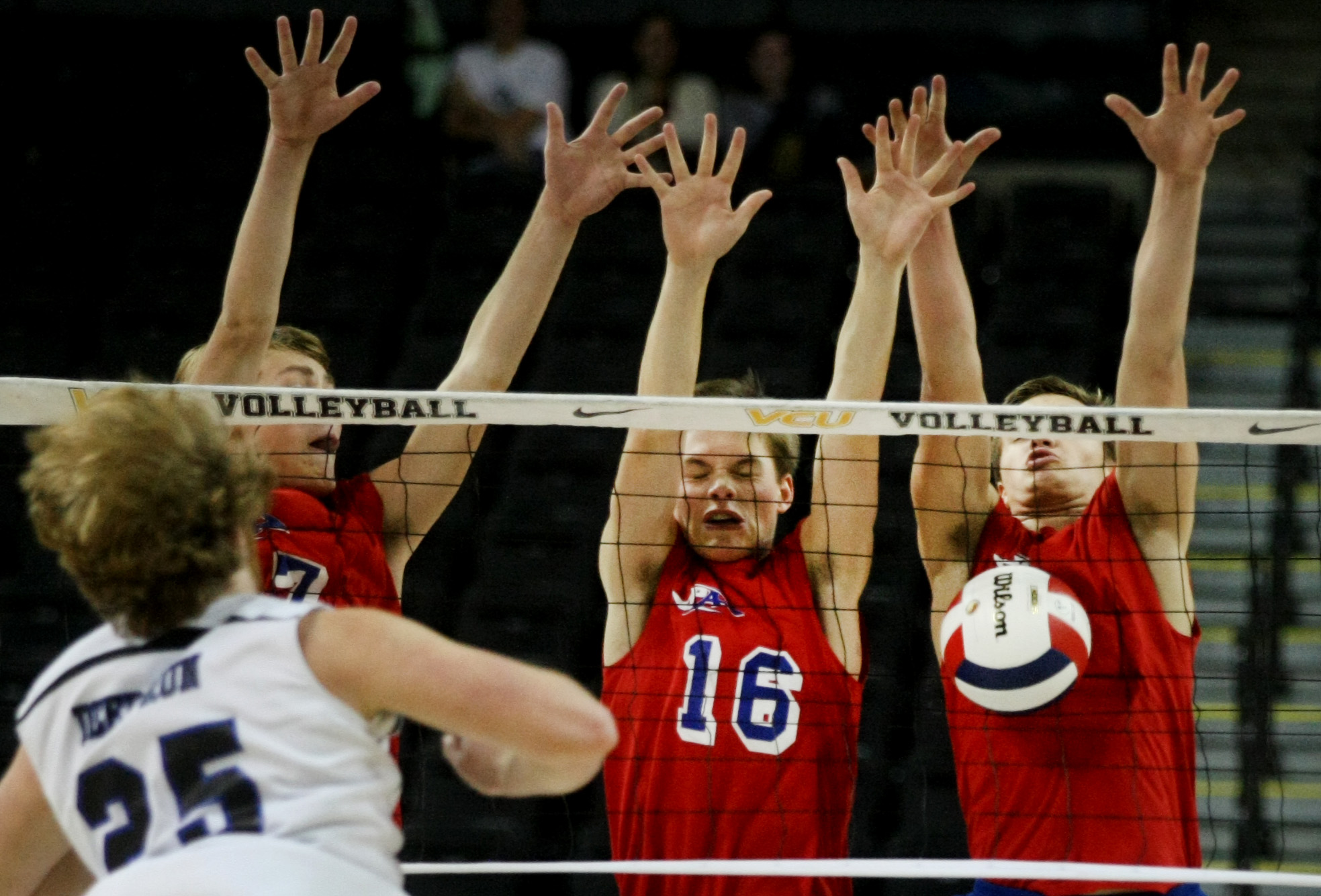 Princess Anne's Courtland Scharenborg, background left, Andrew Butler, center and Chase Howard attack the net on a shot by Deep Run's Craig Nelms during their win to claim the Group 5A boys volleyball state championship, Friday, Nov. 21, 2014 at the Siegel Center in Richmond. (Jason Hirschfeld | For The Virginian-Pilot)