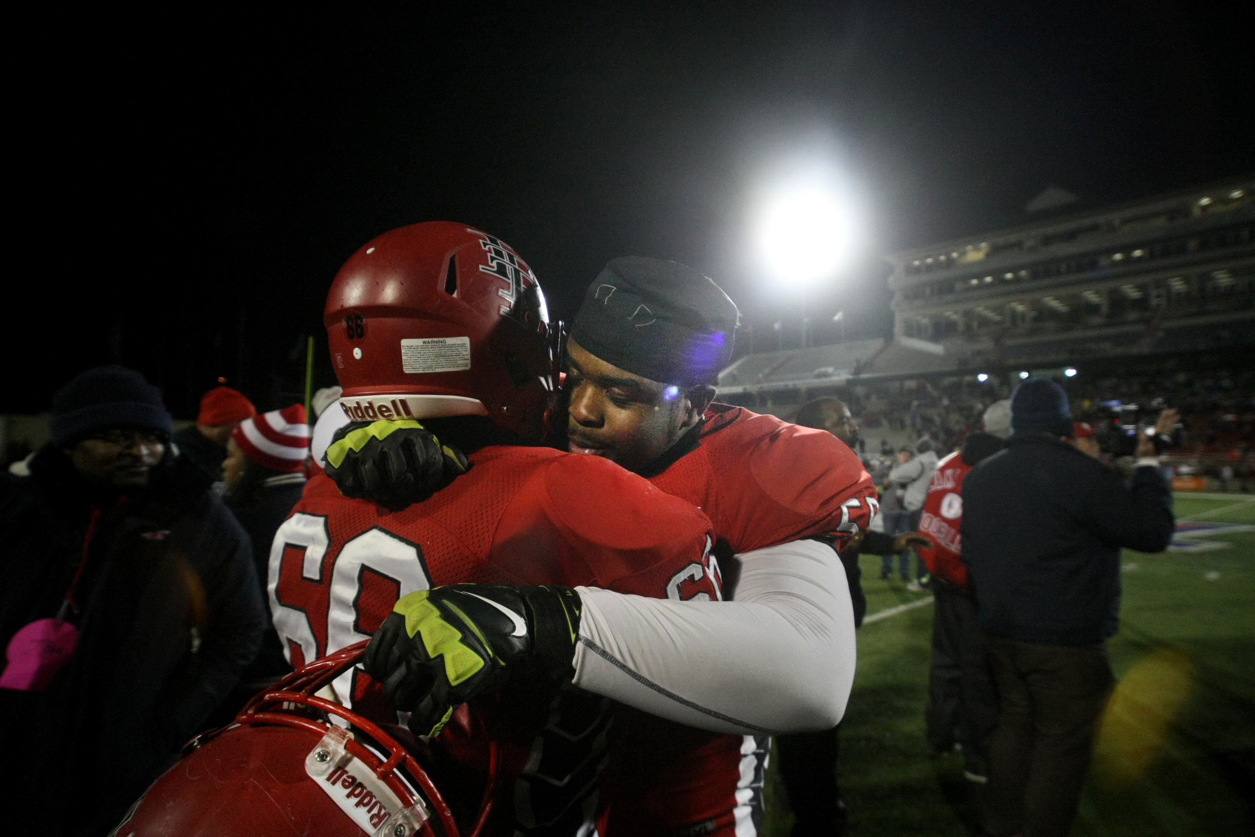 Lake Taylor's Brian Moore, right, celebrates with teammate Anthony Williams after the Titans beat Salem 41-16 to win the Group 4A South championship, Saturday, Dec. 13, 2014 at Williams Field in Lynchburg. (Jason Hirschfeld | For The Virginian-Pilot)