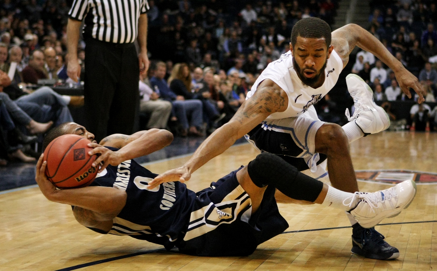 Old Dominion's Aaron Bacote, right, and Charleston Southern's Robert Wilson battle for a loose ball during the first half of an NCAA college basketball game in the National Invitational Tournament, Wednesday, March 23, 2015 in Norfolk, Va. (AP Photo/Jason Hirschfeld)