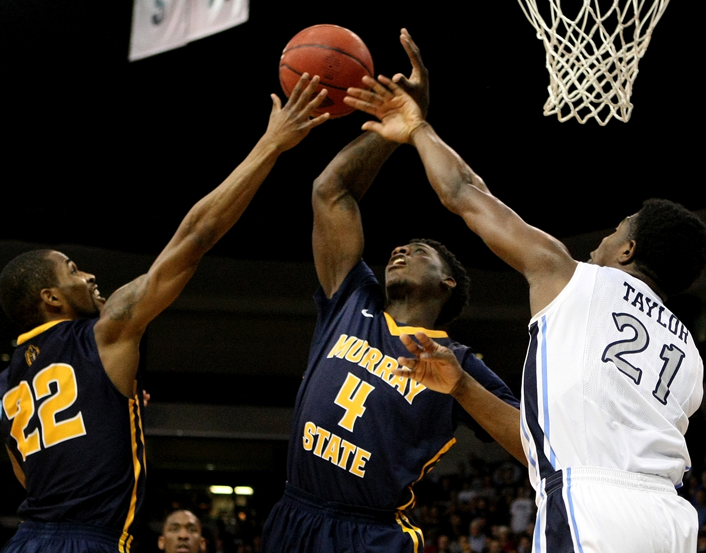 Murray State's T.J. Sapp (22), Jarvis Williams (4) battle Old Dominion's Denzell Taylor for a loose ball during the first half of an NCAA college basketball game in the National Invitation Tournament, Wednesday, March 25, 2015 in Norfolk, Va. (AP Photo/Jason Hirschfeld)