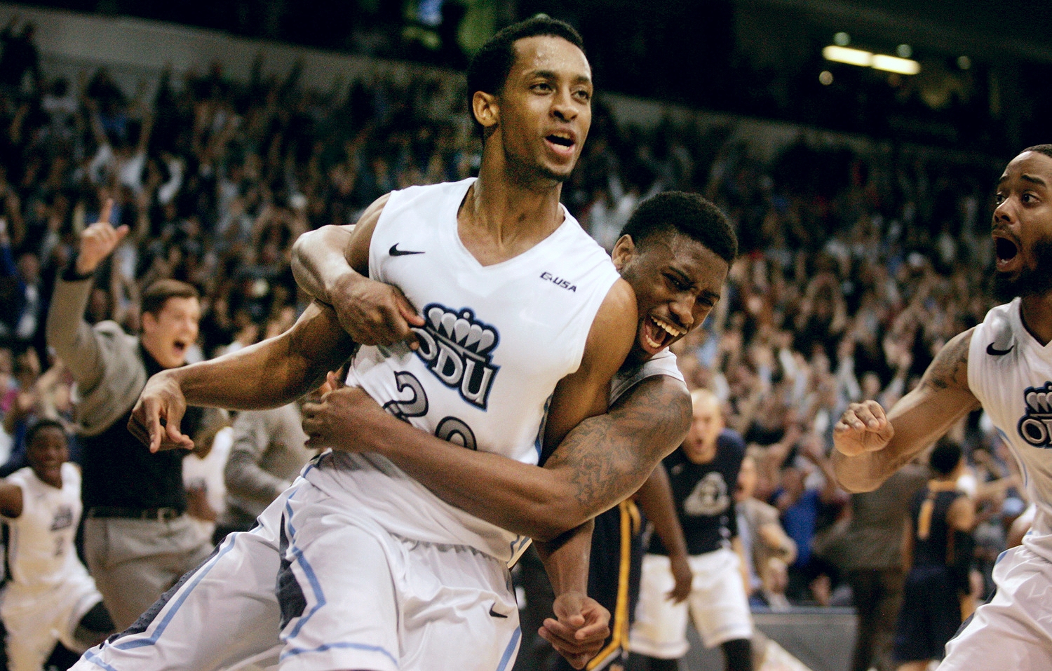 Old Dominion's Trey Freeman (20) is mobbed by teammates after hitting the game-winning shot at the buzzer to beat Murray State 72-69 in an NCAA college basketball game in the National Invitation Tournament, Wednesday, March 25, 2015 in Norfolk, Va. (AP Photo/Jason Hirschfeld)