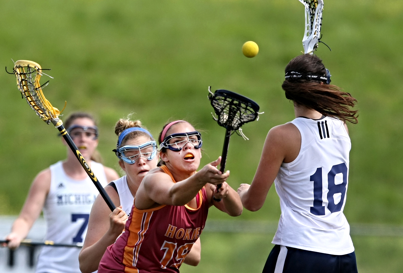 Virginia Tech's Chelsea Denton (19) battles Michigan's Shannon Childress (18) for a loose ball during the women's national lacrosse championship,. Saturday, May 9, 2015 at the Sportsplex in Virginia Beach. (AP Photo/Jason Hirschfeld)