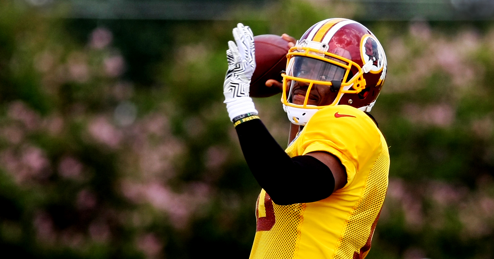 Washington Redskins quarterback Robert Griffin III throws a pass during the team's NFL football training camp in Richmond, Va., Sunday, Aug. 2, 2015. (AP Photo/Jason Hirschfeld)