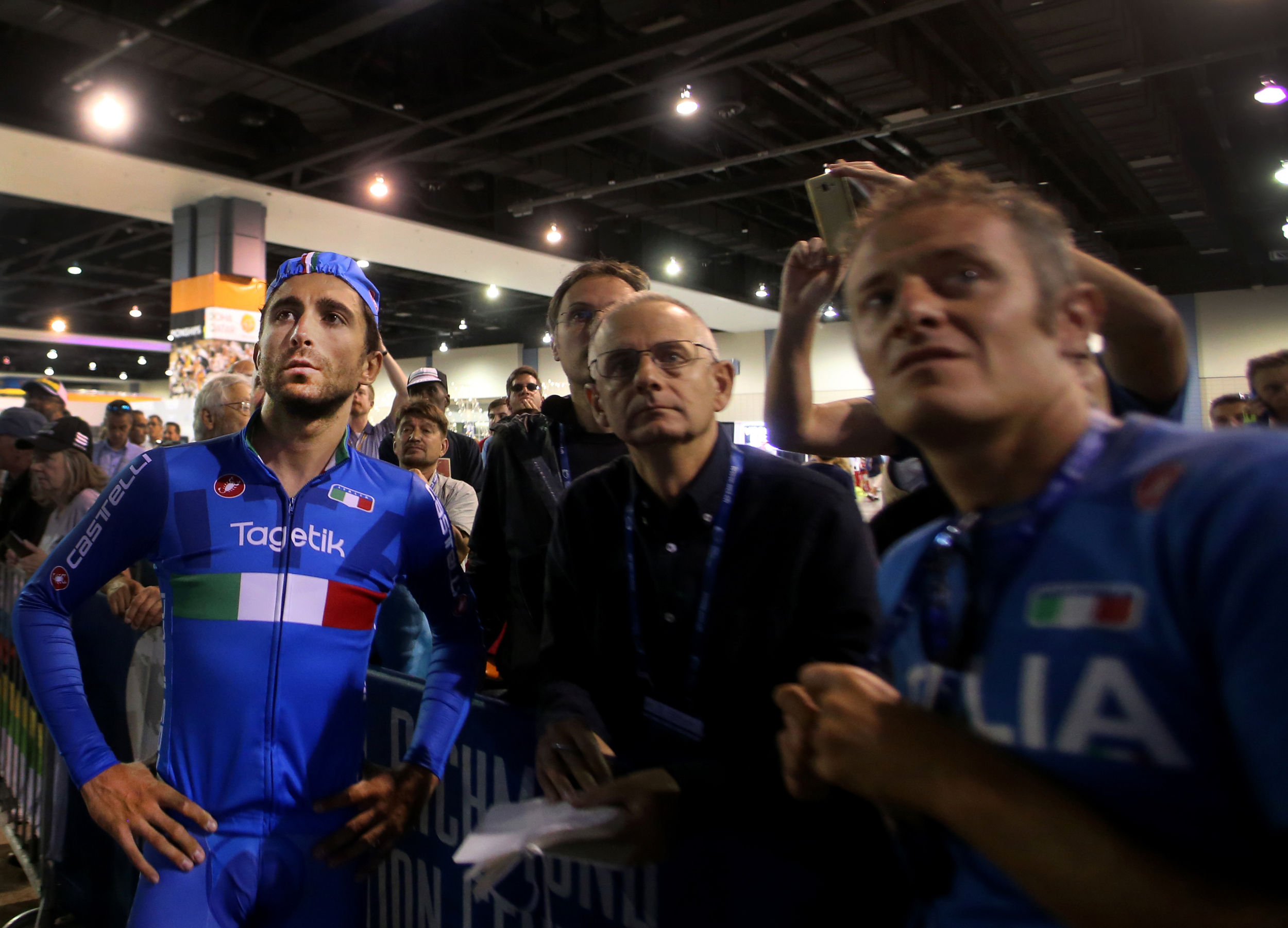 Moreno Moser, of Italy, watches his results on a monitor with team members after finishing the men's elite time trials at the UCI Road World Championships Cycling Races in Richmond, Va., Wednesday, Sept. 23, 2015. (AP Photo/Jason Hirschfeld)