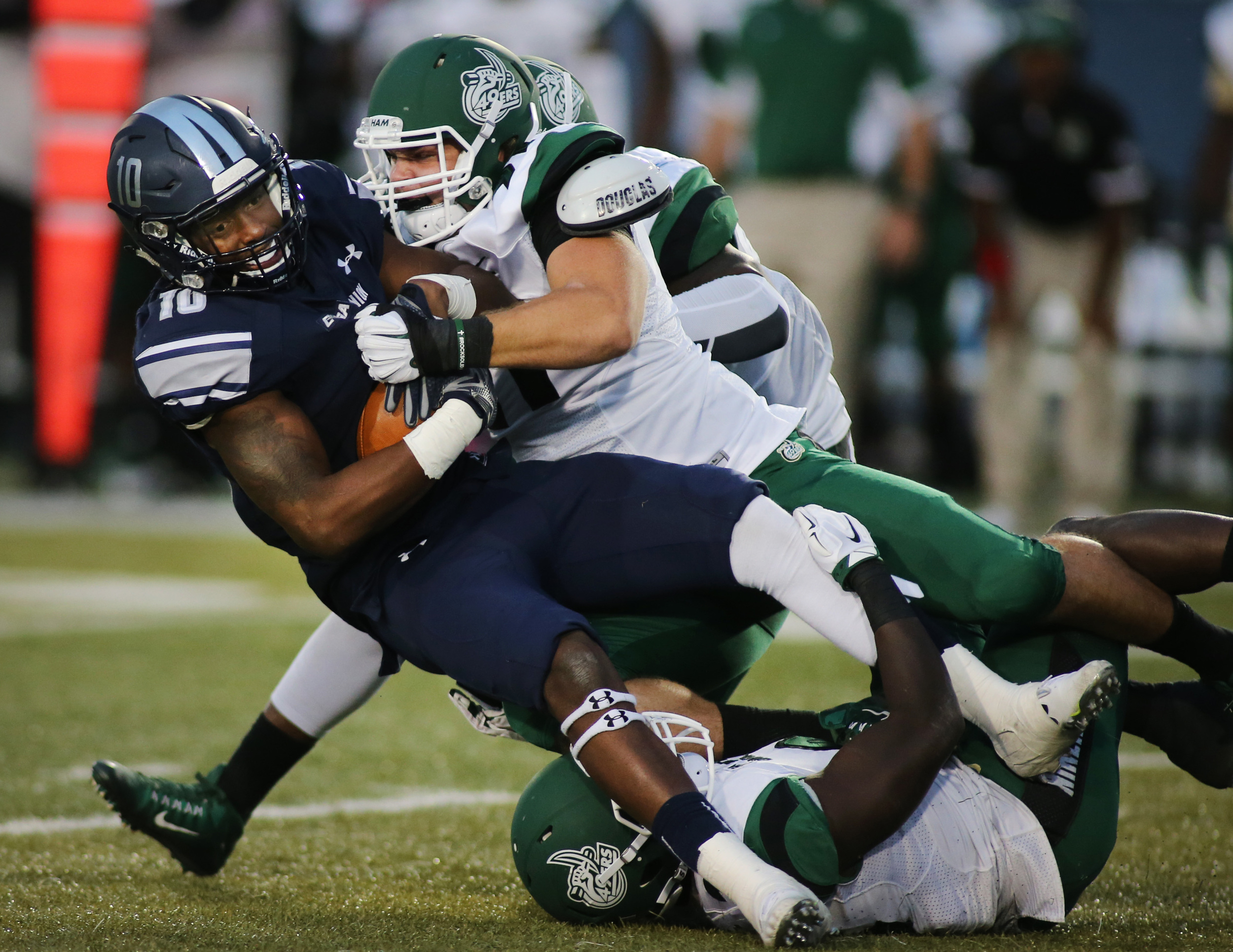 Old Dominion's David Washington is brought down by Charlotte's Nick Carroll in the third quarter of ODU's 37-34 win , Saturday, Oct. 17, 2015 at Foreman Field in Norfolk. (Jason Hirschfeld | For The Virginian-Pilot)