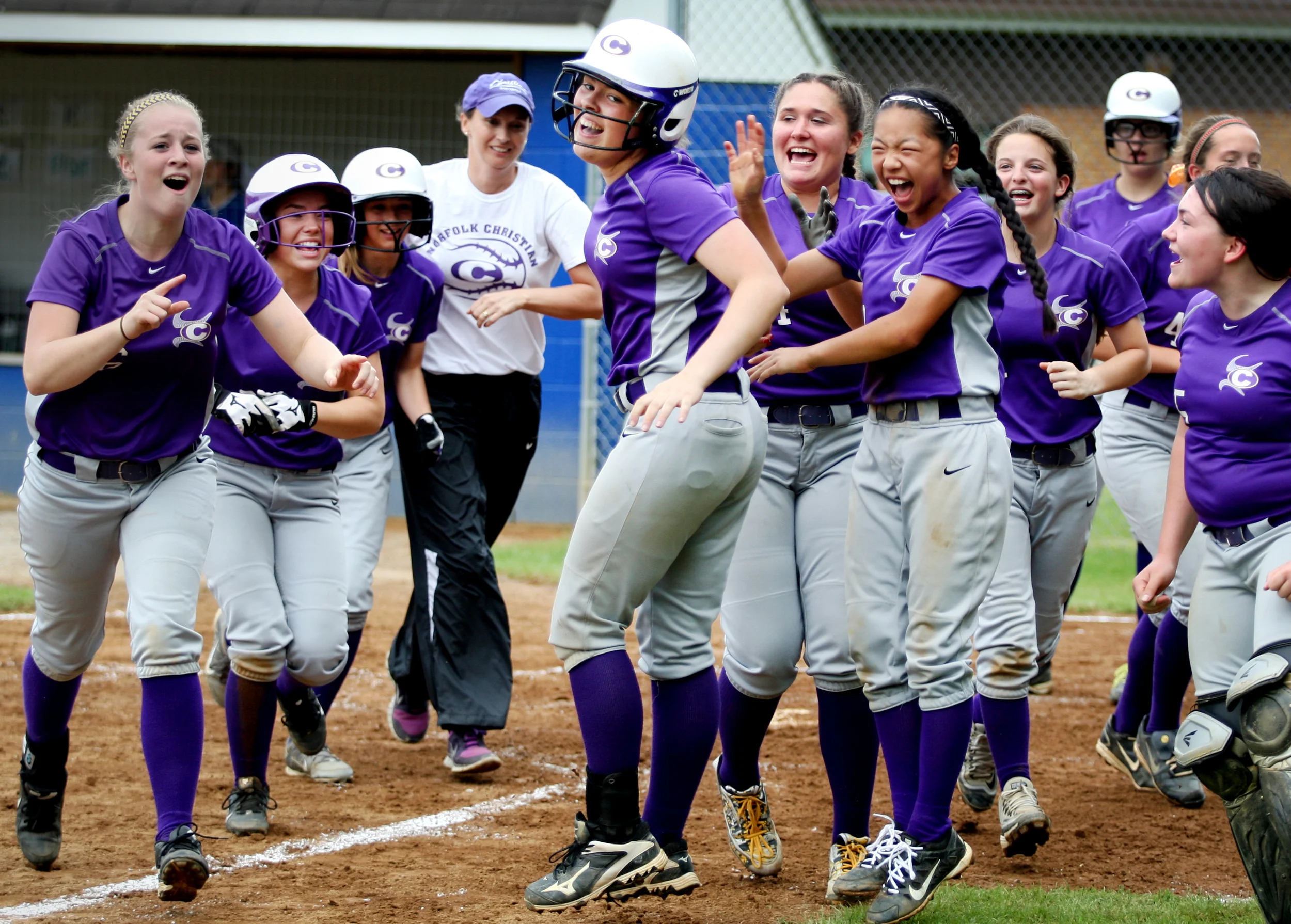 Norfolk Christian's Rilee (cq) Jones, center, is mobbed by teammates after belting a three-run homerun in the top of the fifth inning but fell to Nansemond-Suffolk 4-3 in the TCIS semifinal, Thursday, May 12, 2016 in Suffolk.
