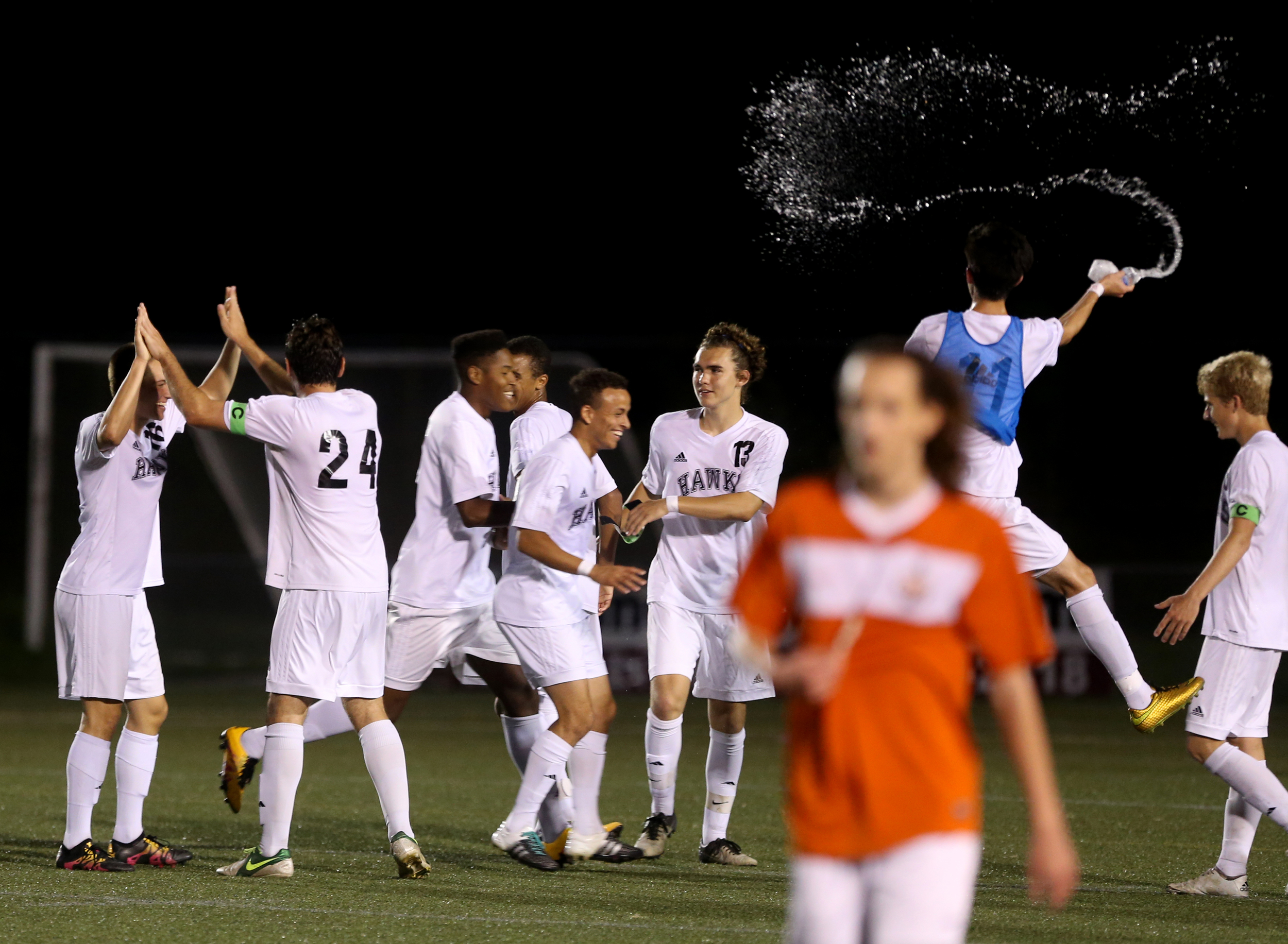 Maury's Zach Harris, foreground, walks off as Hickory celebrates their 2-0 win to advance in the Group 5A South Region semifinals, Wednesday, June 1, 2016 at the Sportsplex in Virginia Beach.