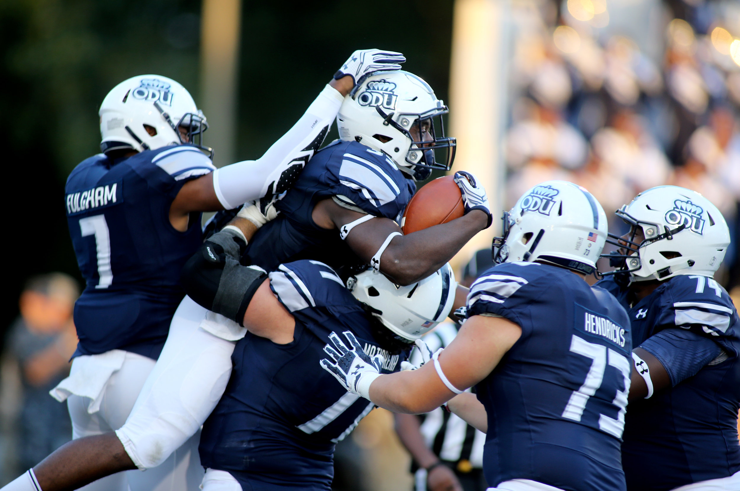 Teammates celebrate with Old Dominion's Jeremy Cox, center with ball, after he scored a fourth quarter touchdown during ODU's 54-21 win, Sunday, Sept. 4, 2016 at Foreman Field in Norfolk. (Jason Hirschfeld | The Virginian-Pilot)