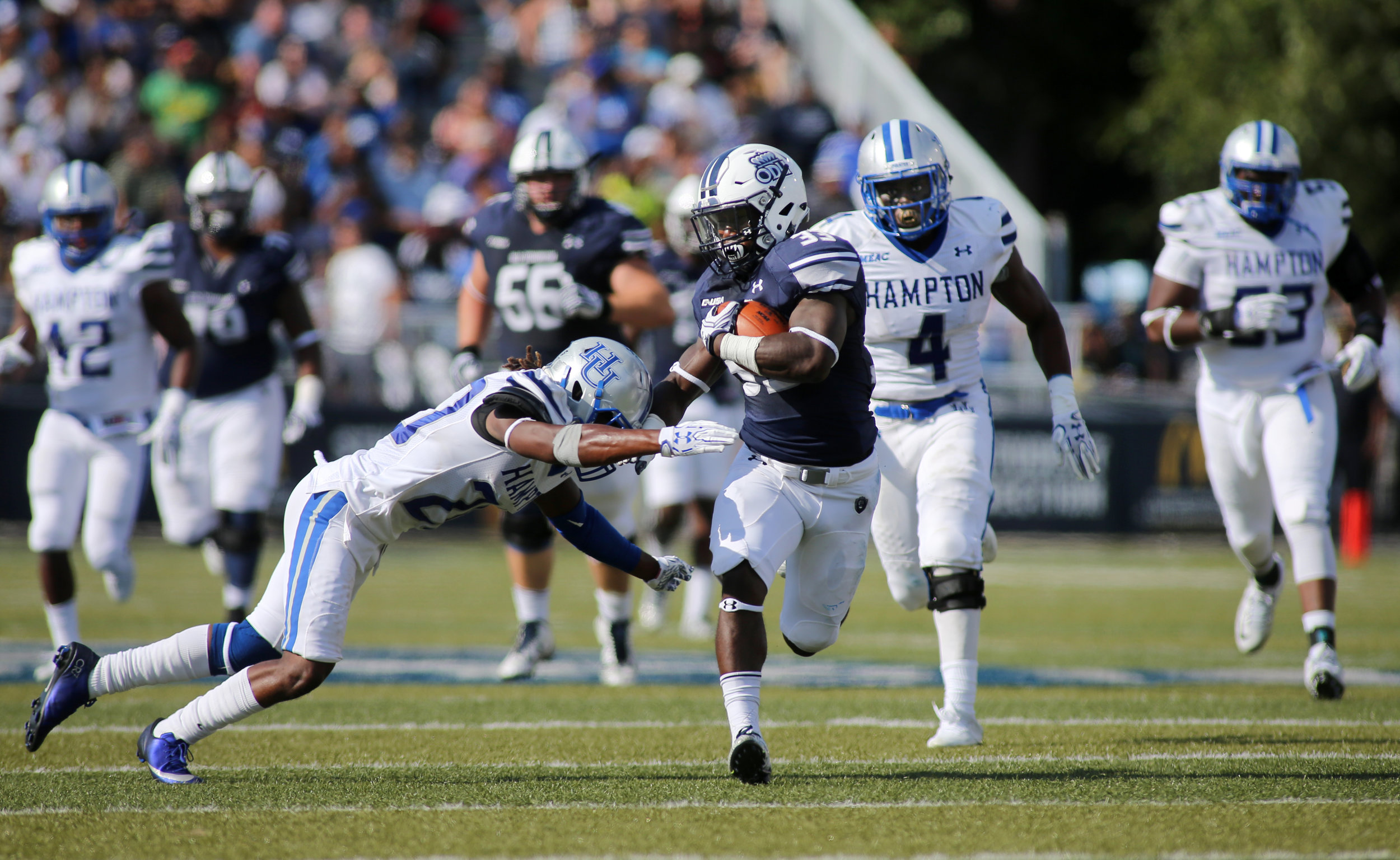 Old Dominion's Ray Lawry finds a seam past Hampton defender Myles Morris for a second quarter gain, Sunday, Sept. 4, 2016 at Foreman Field in Norfolk. (Jason Hirschfeld | The Virginian-Pilot) 
