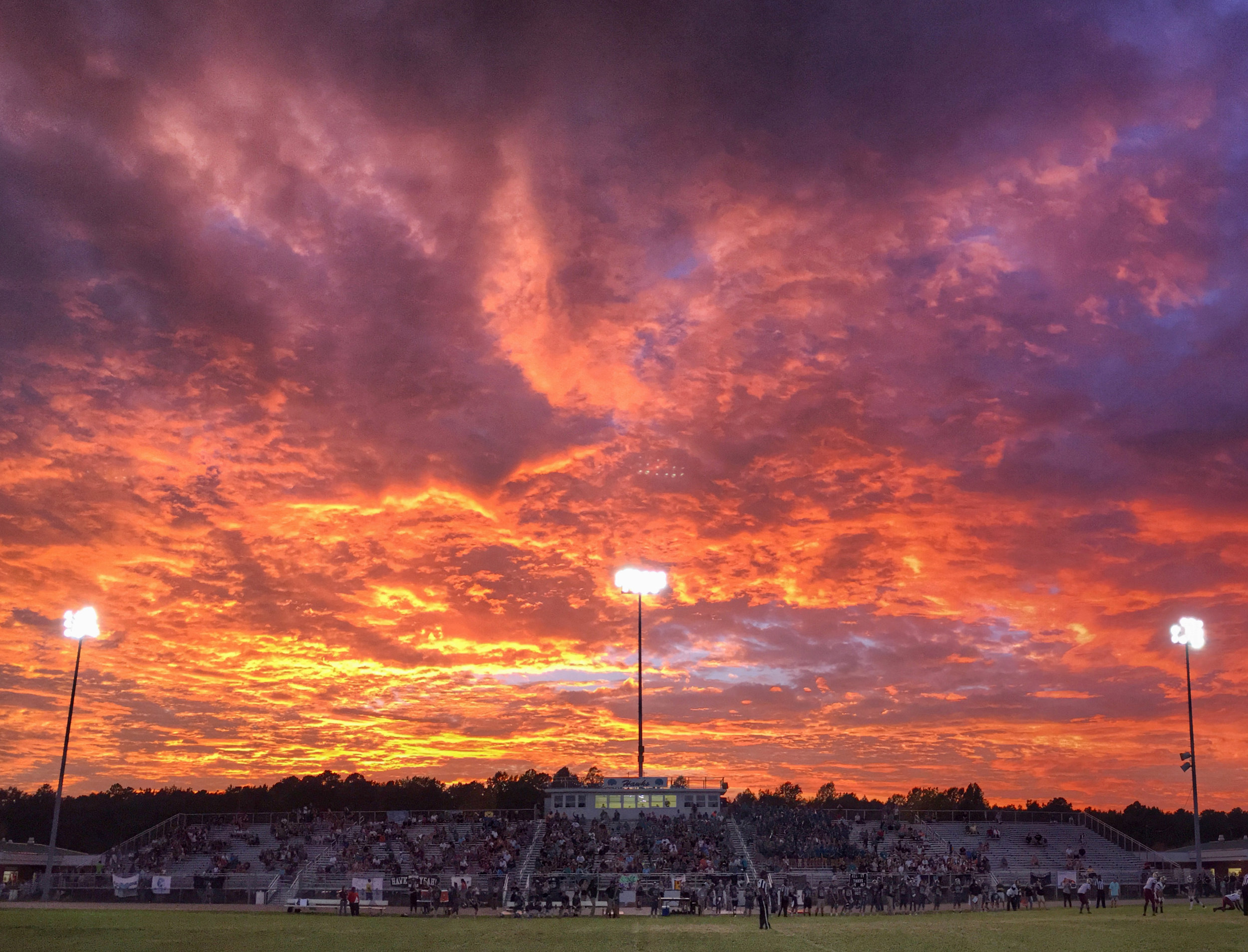 A dynamic sunset takes place during the King's Fork at Hickory football game, Friday, Sept. 10, 2016 at Hickory High School in Chesapeake. (Jason Hirschfeld | The Virginian-Pilot)