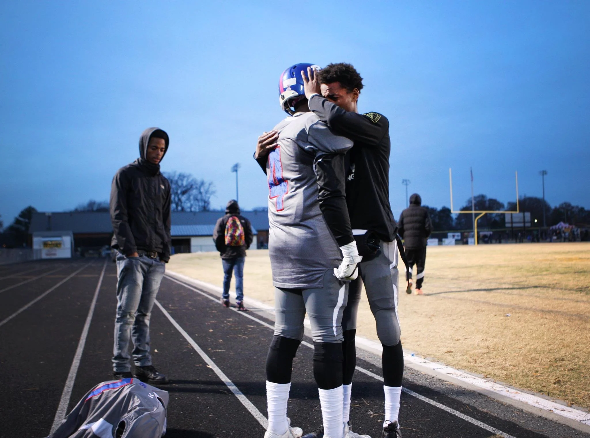 Norview's Kavon Lawson (4) and teammate Jamal Deaton embrace after losing to Highland Springs in the 5A South Region championship game, Saturday, Dec. 4, 2016 in Highland Springs, Va. 