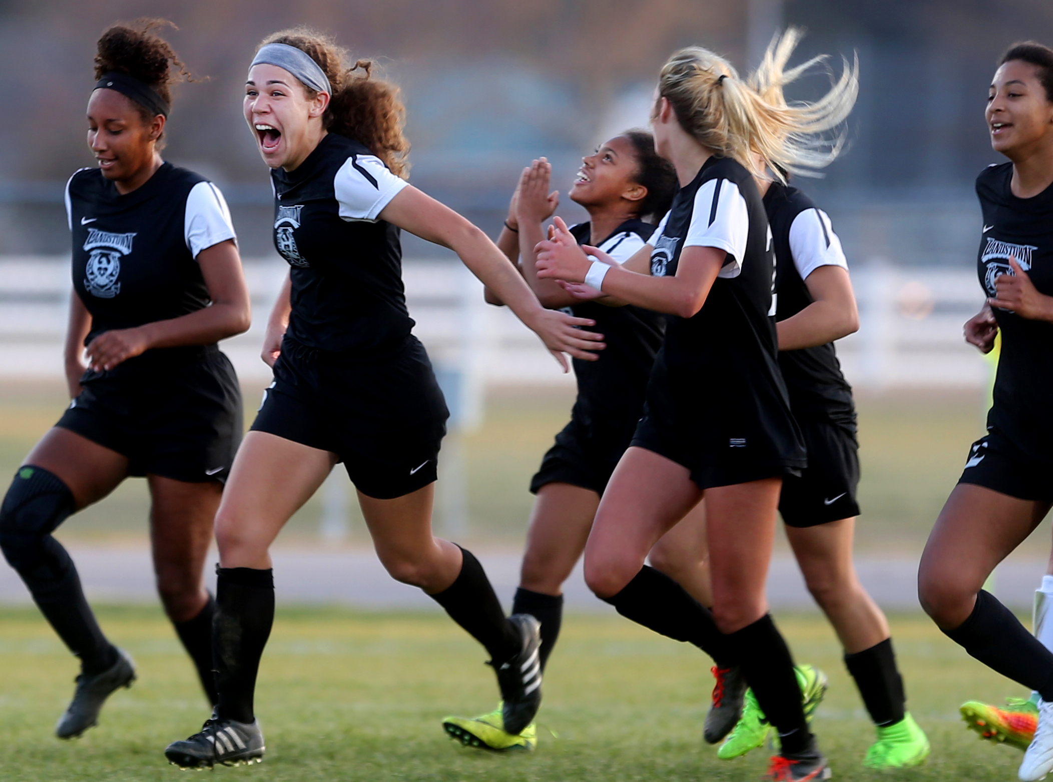 Landstown's Trinity Sudderth, second from left, celebrates after her goal tied the match 1-1 in the closing seconds of their draw against Cox, Tuesday, March 21, 2017 at Cox high School in Virginia Beach.
