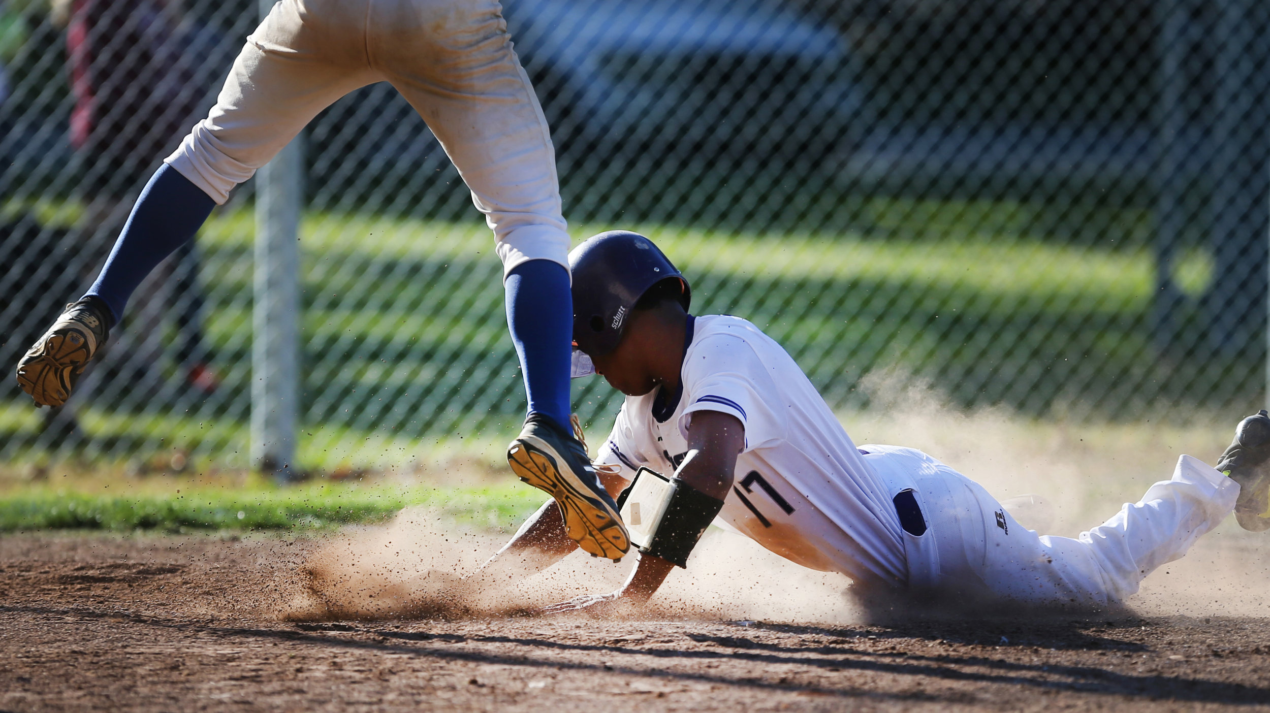 Norfolk Christian's Baraka Florence slides safely into home during the Ambassadors' 19-2 rout over Norfolk Collegiate in the TCIS quarterfinals, Tuesday, May 9, 2017 at Lakewood Park in Norfolk. 