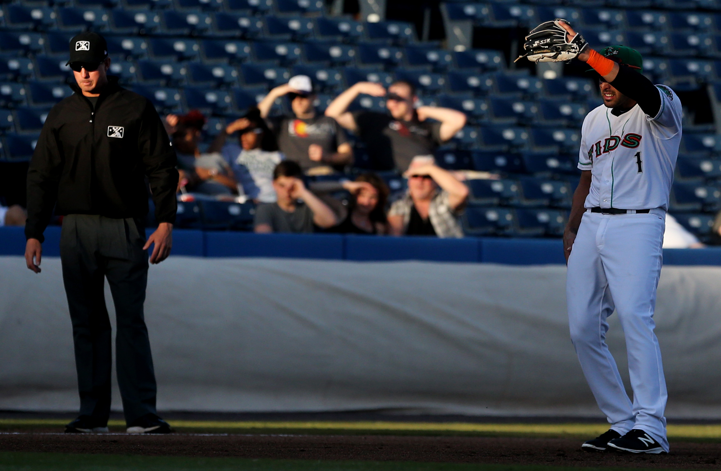 Tides third baseman Alex Castellanos shields his eyes from the setting sun during their game against Gwinnett, Tuesday, April 11, 2017 at Harbor Park in Norfolk.