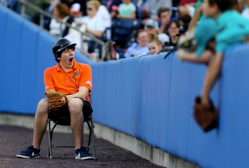 A Tides gameday worker yawns on Opening Night against Gwinnett at Harbor Park in Norfolk.