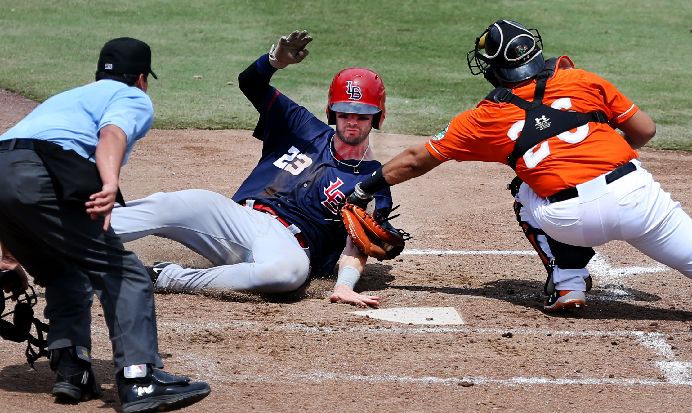  Tides catcher Francisco Pena tags out Louisville's Jesse Winker after centerfielder Craig Gentry threw a strike to home during the Tides' 4-3 walk off win, Sunday, June 18, 2017 at Harbor Park. 